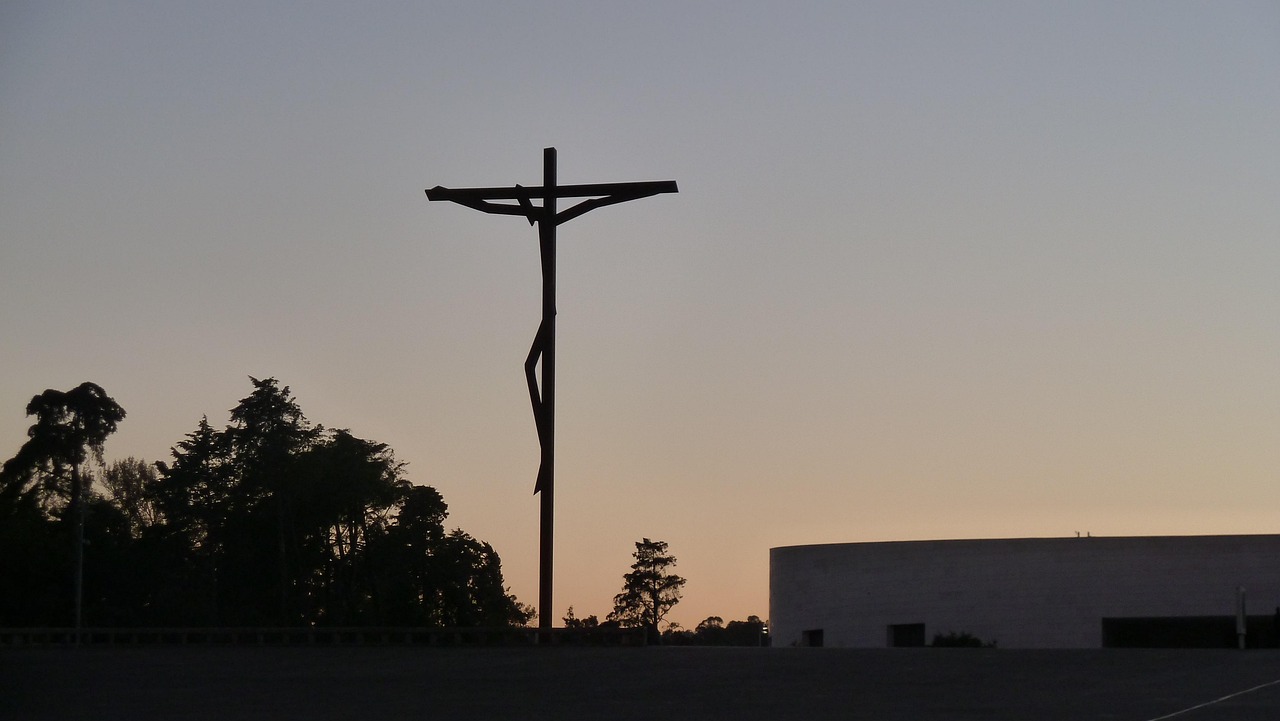 Silhouette of a crucifix statue at sunset in Fatima Portugal