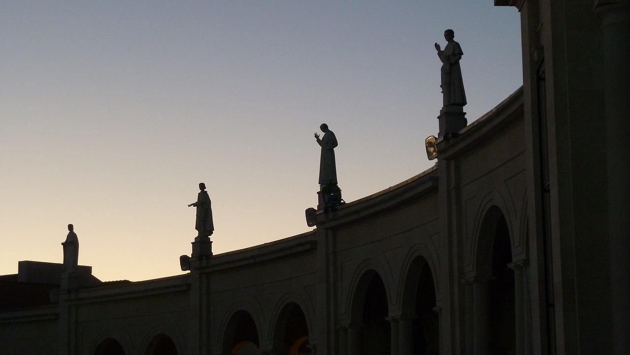 Silhouette of religious statues against the sky at Fatima Portugal