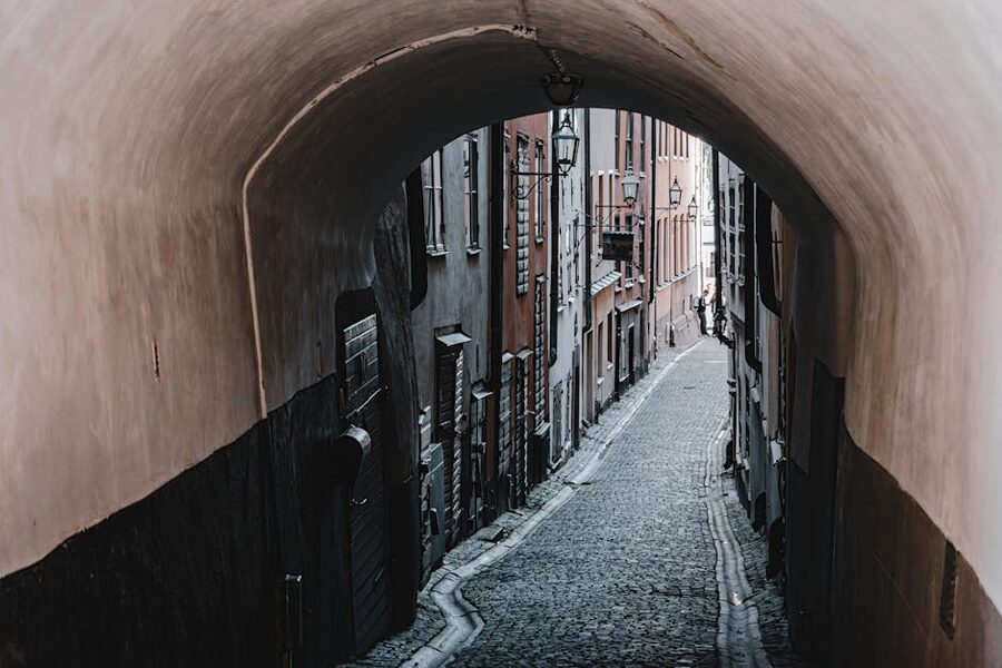 Cobblestone alleyway with stone archway in Gamla Stan Old Town Stockholm