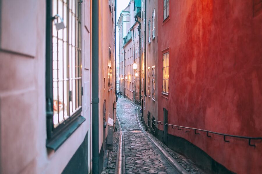 Narrow cobblestone pedestrian passage in Gamla Stan Old Town Stockholm in evening