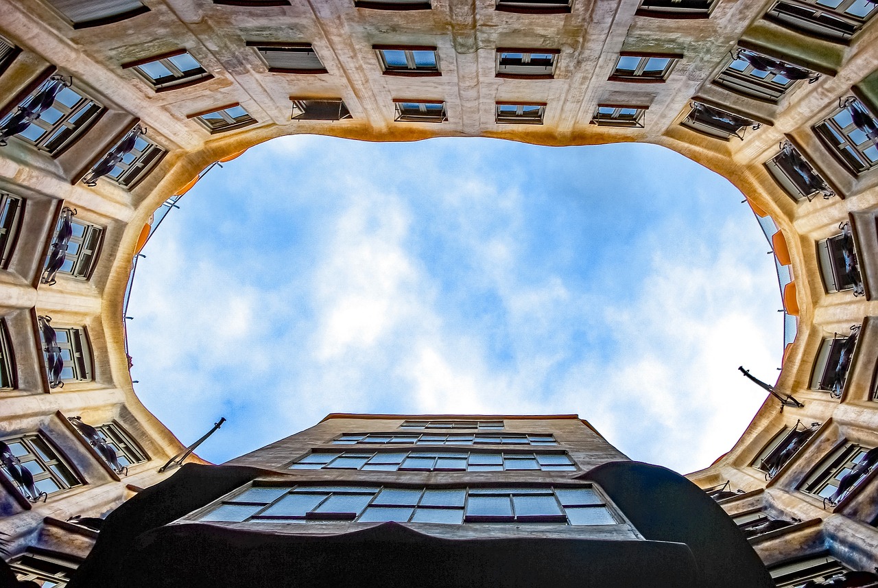 Gaudi building rooftop in Barcelona showing sculptural chimneys and mosaic tile work