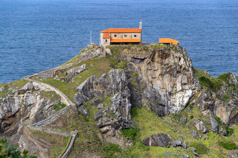Chapel on Gaztelugatxe islet with vast Atlantic Ocean behind it