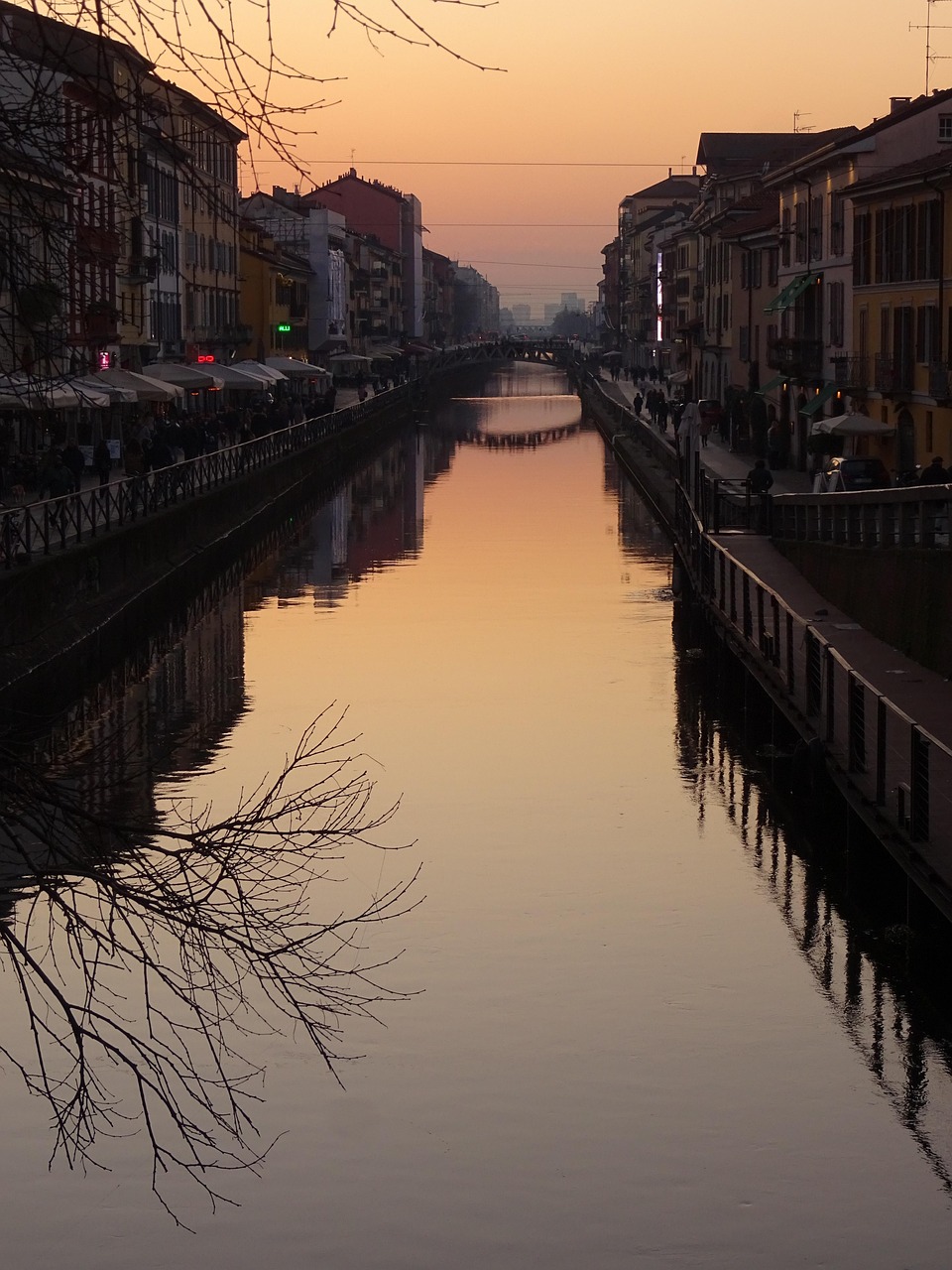 Sunset silhouette over a bridge on the Naviglio Grande canal in Milan