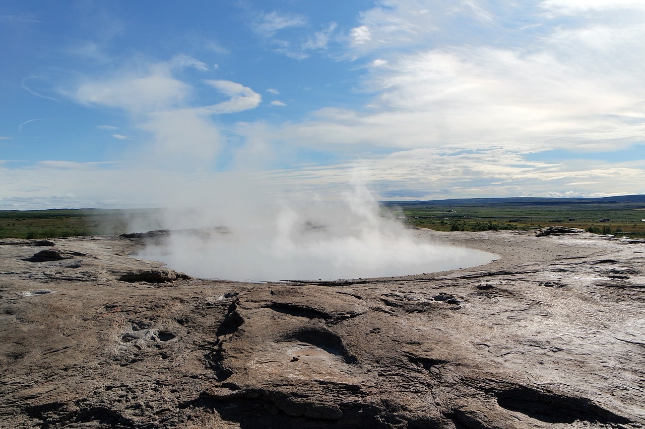 Geysir geothermal area with hot springs and steam in Iceland landscape