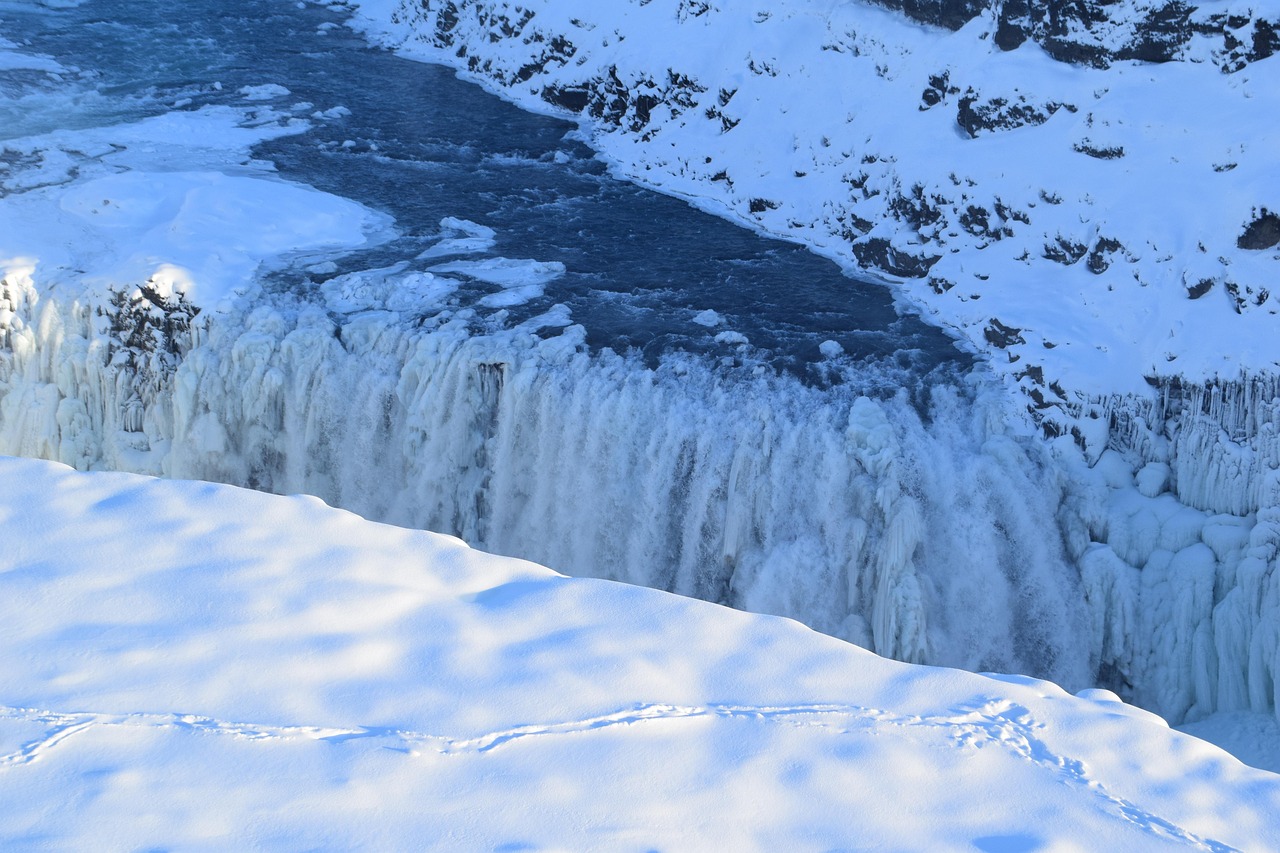 Gullfoss waterfall partially frozen in winter with ice and snow in Iceland