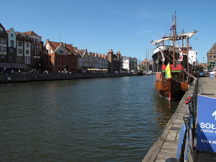 Tourist boat passing through Gdańsk Old Town along the Motława