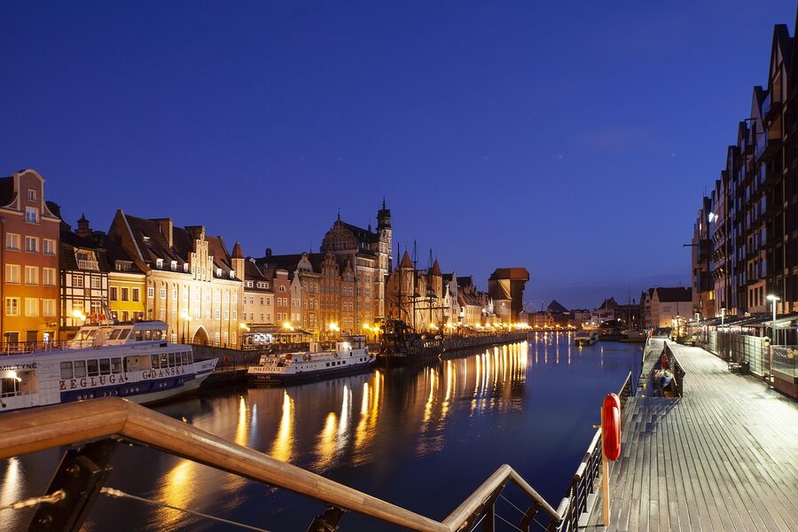 Gdansk old town river at night with monuments illuminated