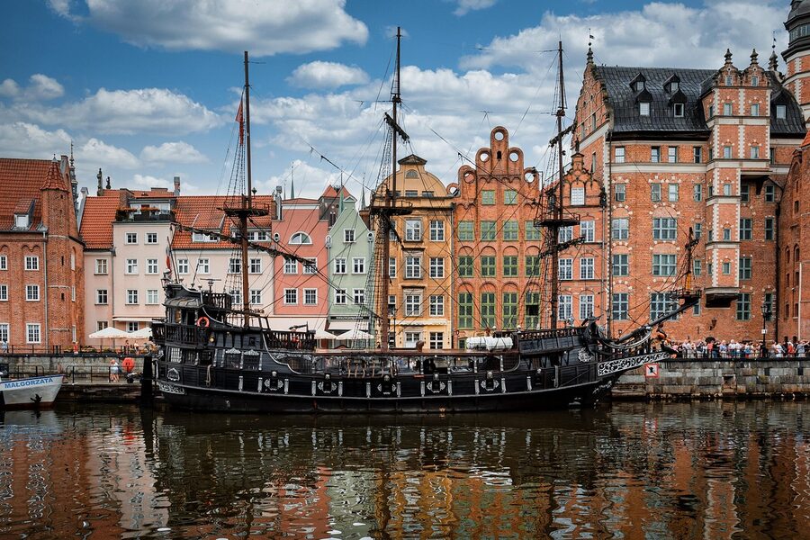 Wooden sailing ship moored in front of Gdańsk Old Town facades