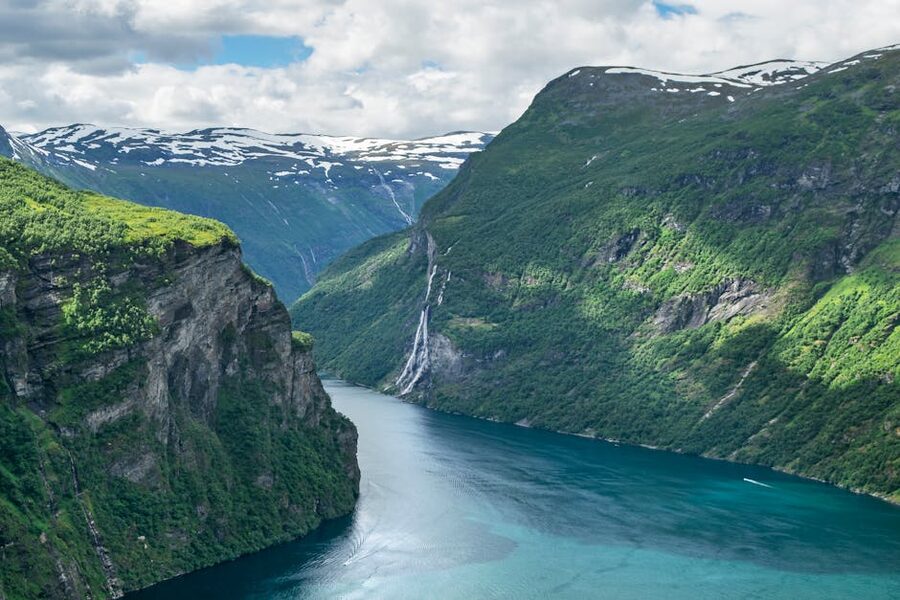 Geirangerfjord cliffs and waterfall under bright sky