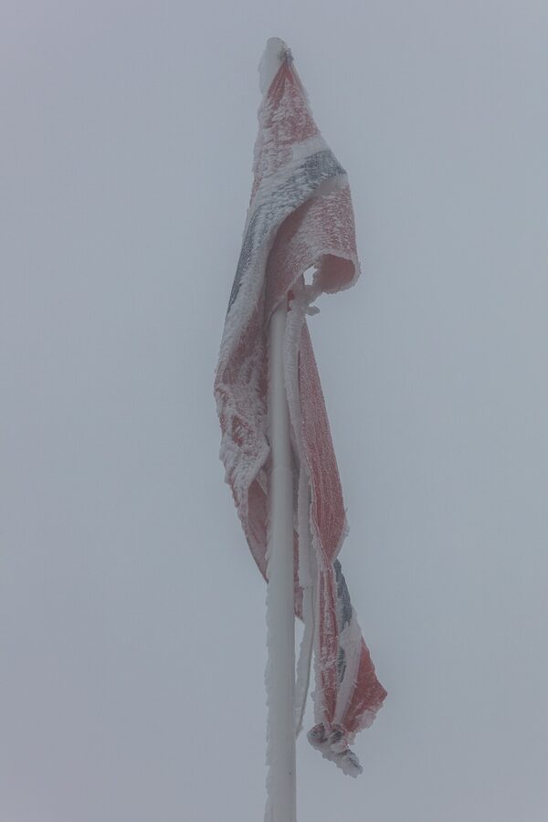 Frozen Norwegian flag at Dalsnibba 1500m viewpoint