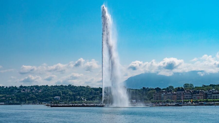Geneva Jet d Eau against blue sky and mountains
