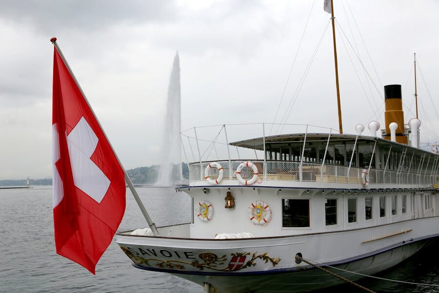 Historic paddle steamer with Swiss flag on Lake Geneva