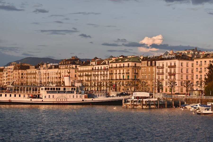 Geneva waterfront with historic architecture at sunset