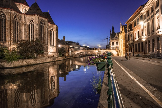Ghent canal and medieval buildings illuminated at night Belgium