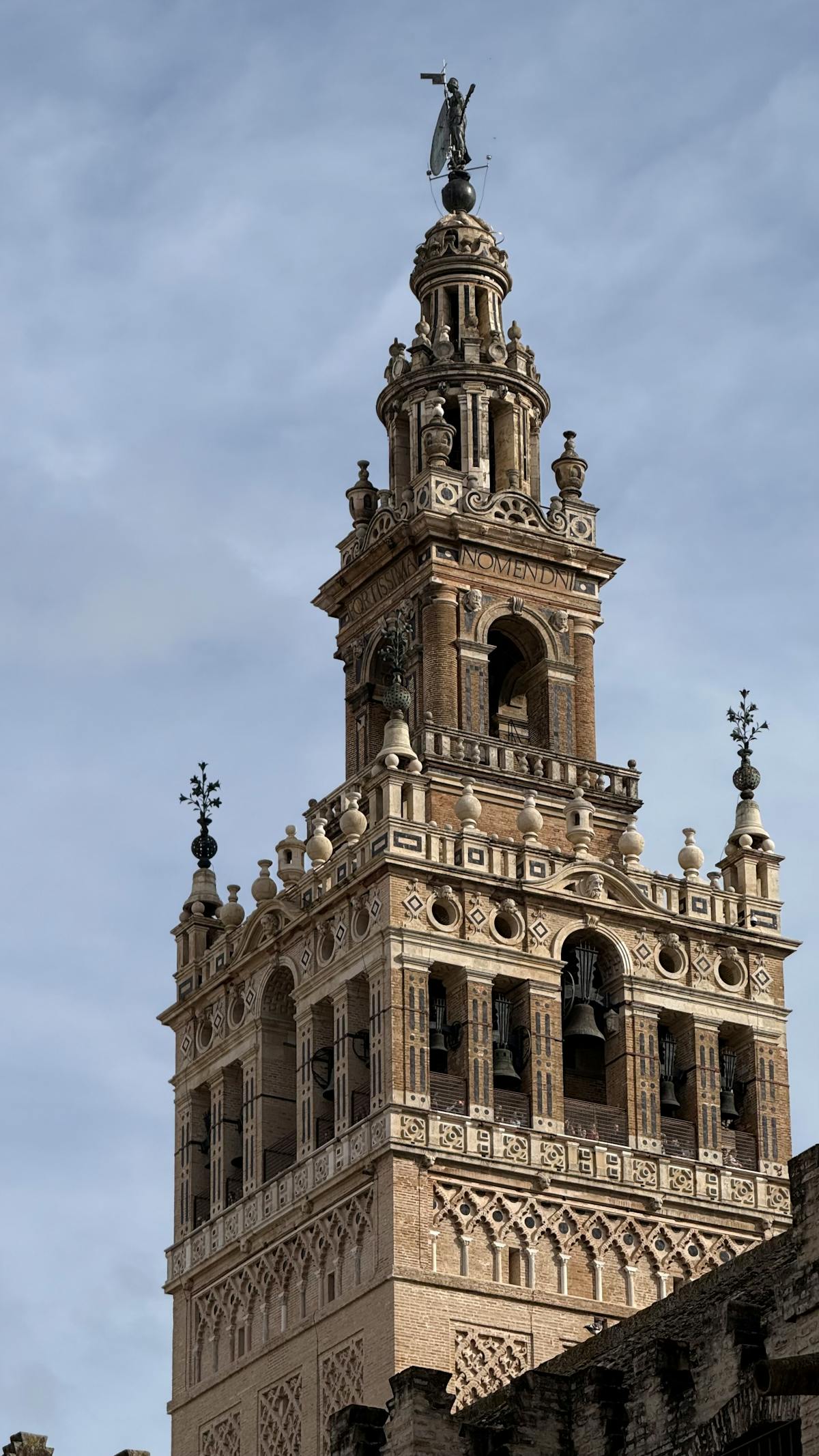 Close-up of the Giralda tower showing ornate Moorish brickwork and arched windows