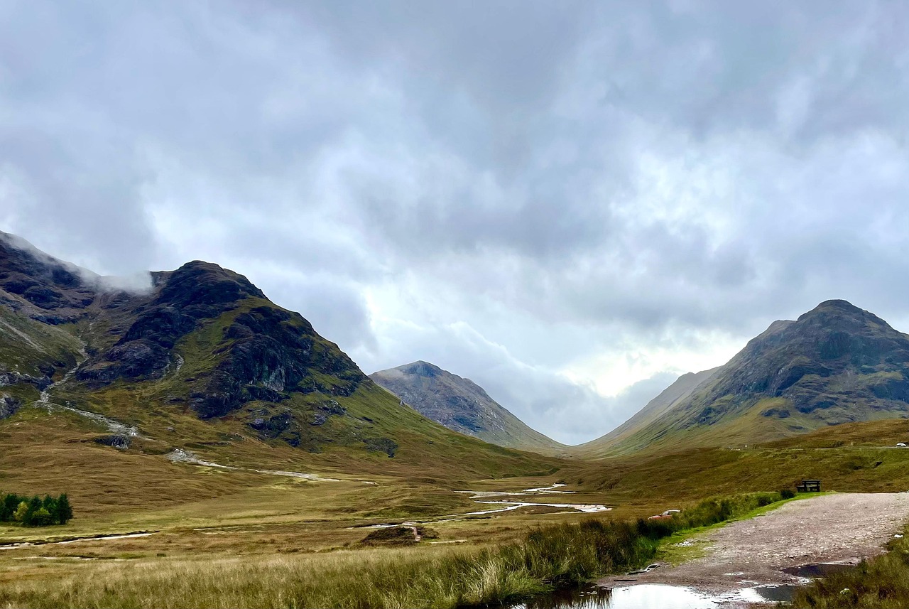 Rolling green hills and dramatic landscape of the Scottish Highlands near Glencoe