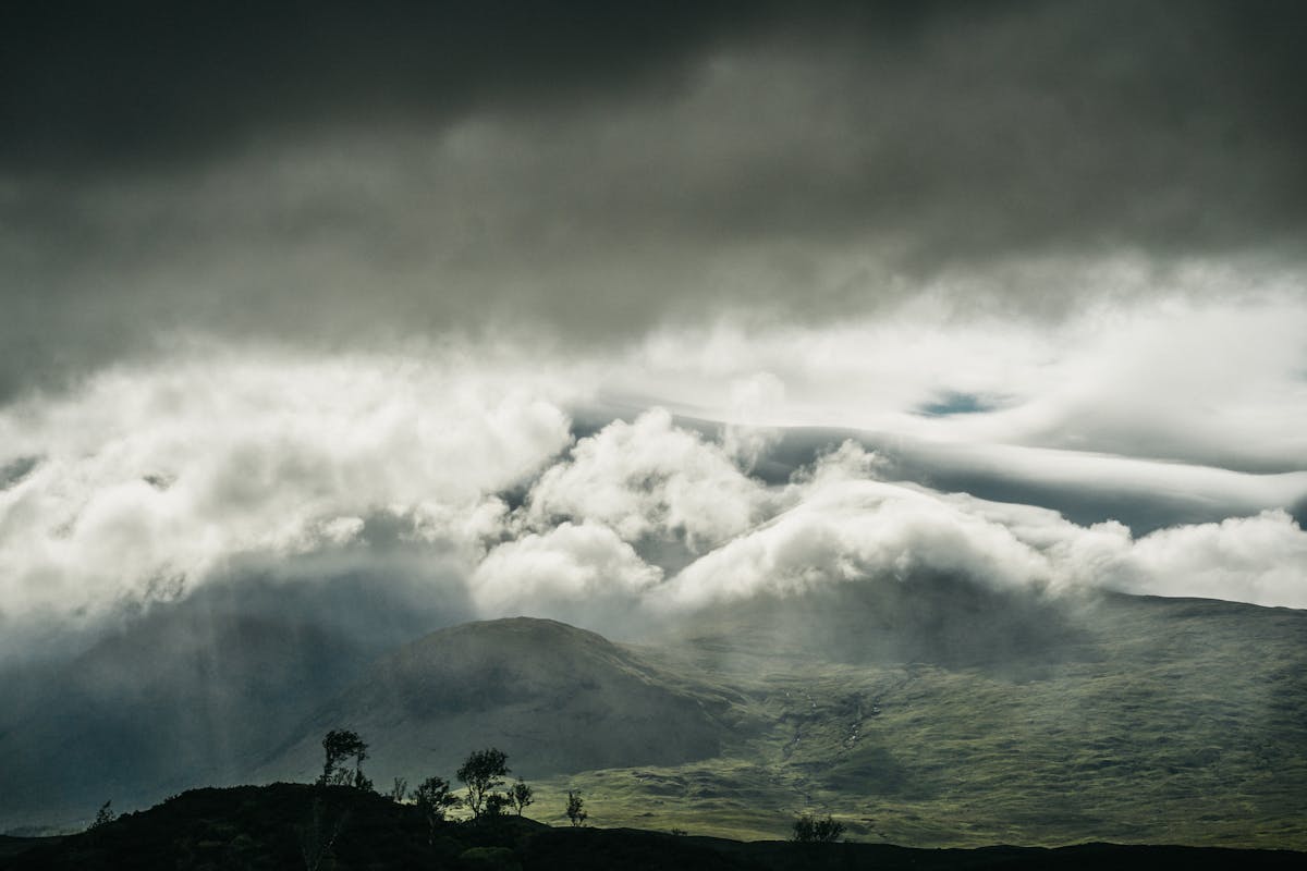 Clouds rolling over lush green mountains of Glencoe Scotland