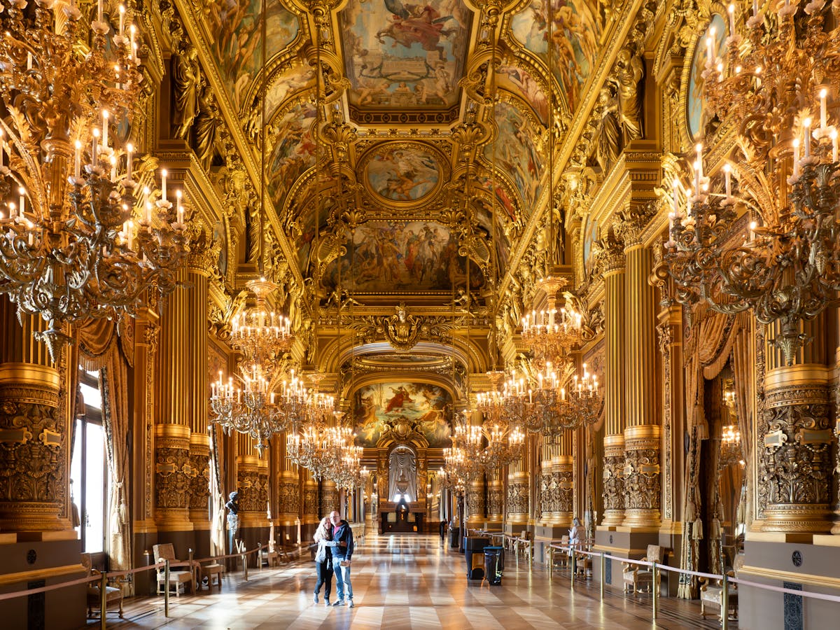 The golden Grand Foyer inside the Palais Garnier with ornate decorations