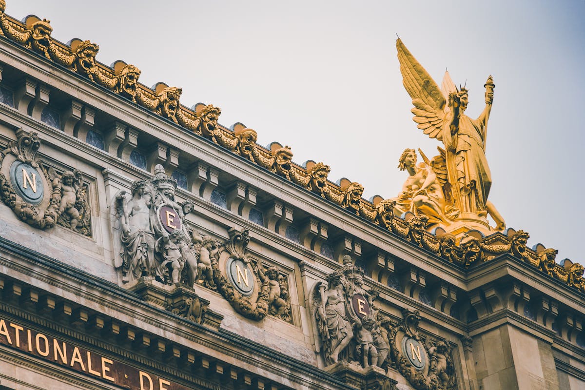 Ornate sculptures and golden statues on the facade of the Palais Garnier in Paris