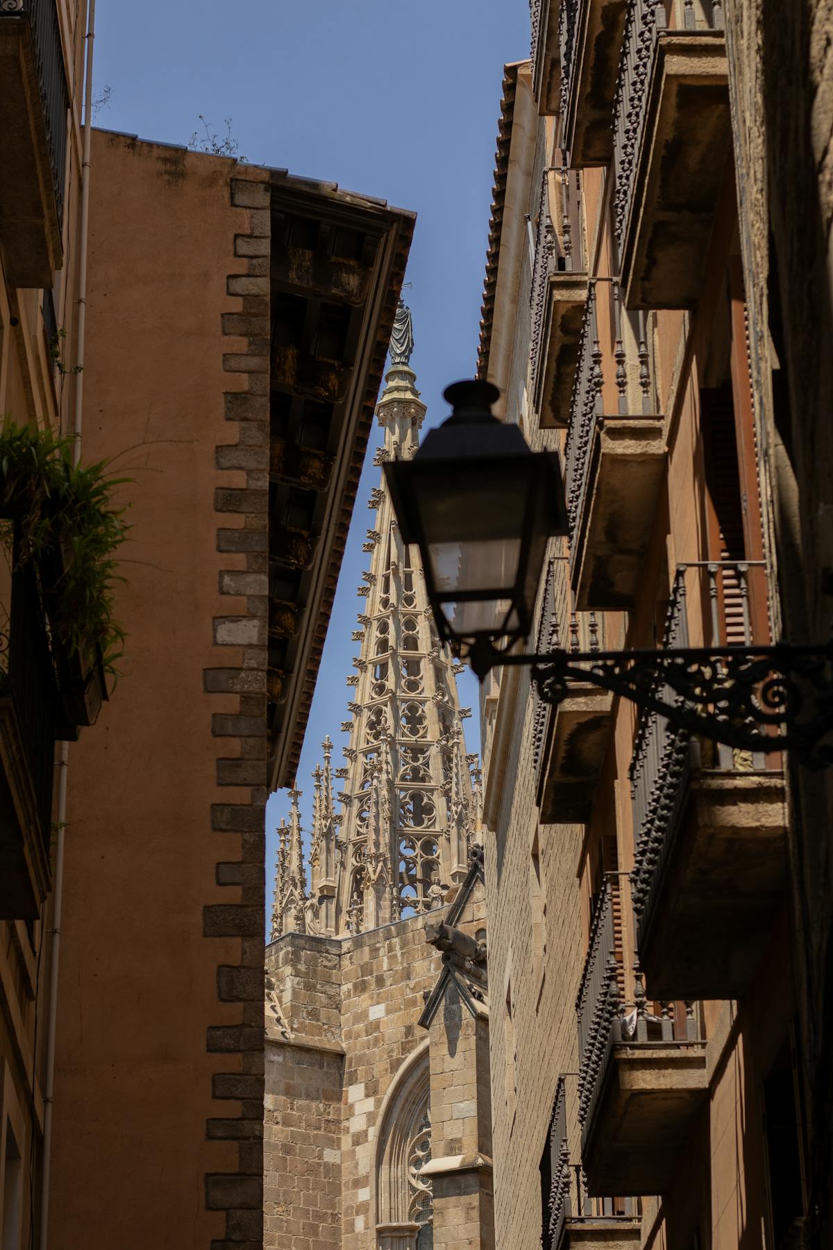 Barcelona Cathedral spire through narrow Gothic Quarter streets