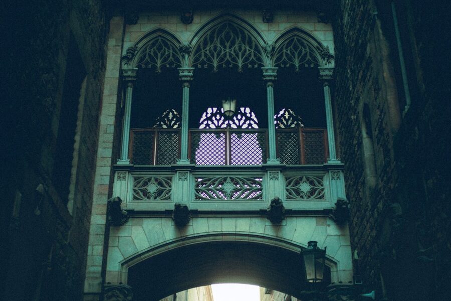 Green-lit Gothic architectural detail in Barcelona at night