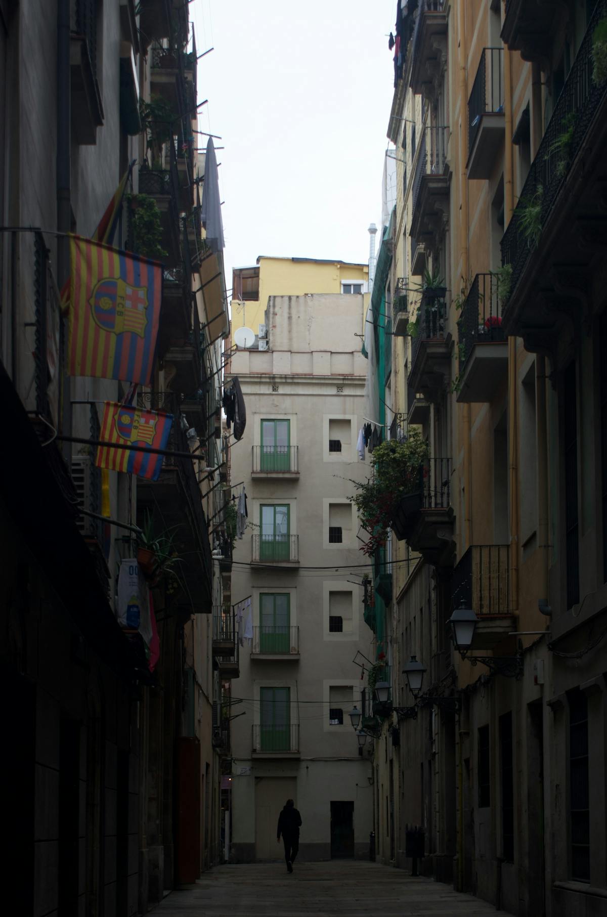 Narrow street with balconies in Barcelona Gothic Quarter