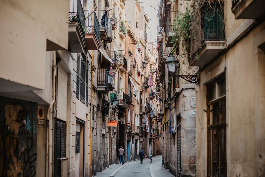 Historic narrow street in Barcelona Gothic Quarter with wrought iron balconies