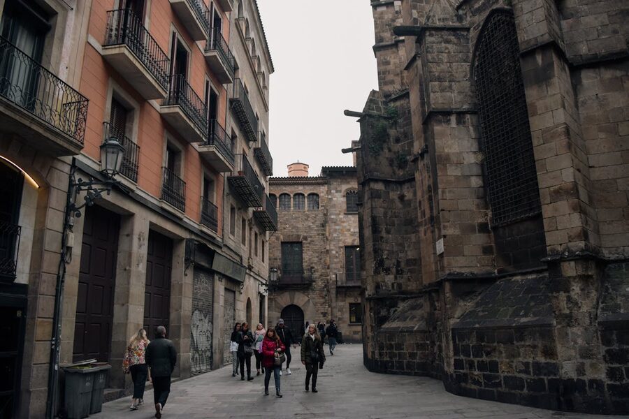 People walking through a busy alley in Barcelona Gothic Quarter