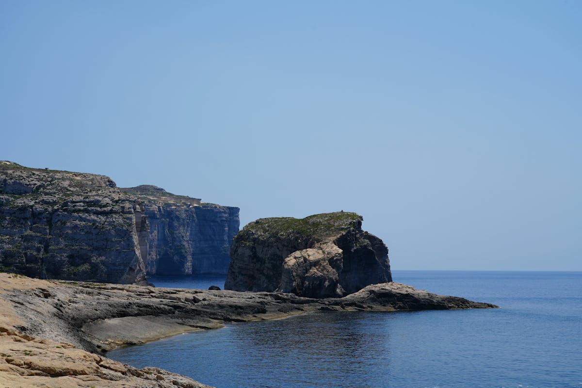 Dramatic coastal cliffs with clear blue sea in Gozo Malta