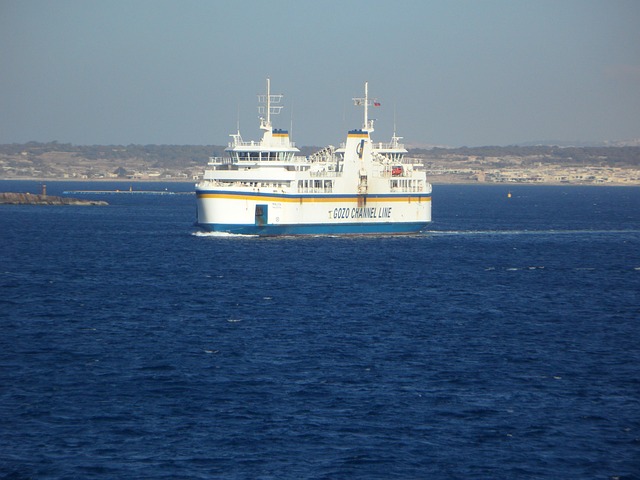 Car ferry between Malta and Gozo passing Comino cliffs