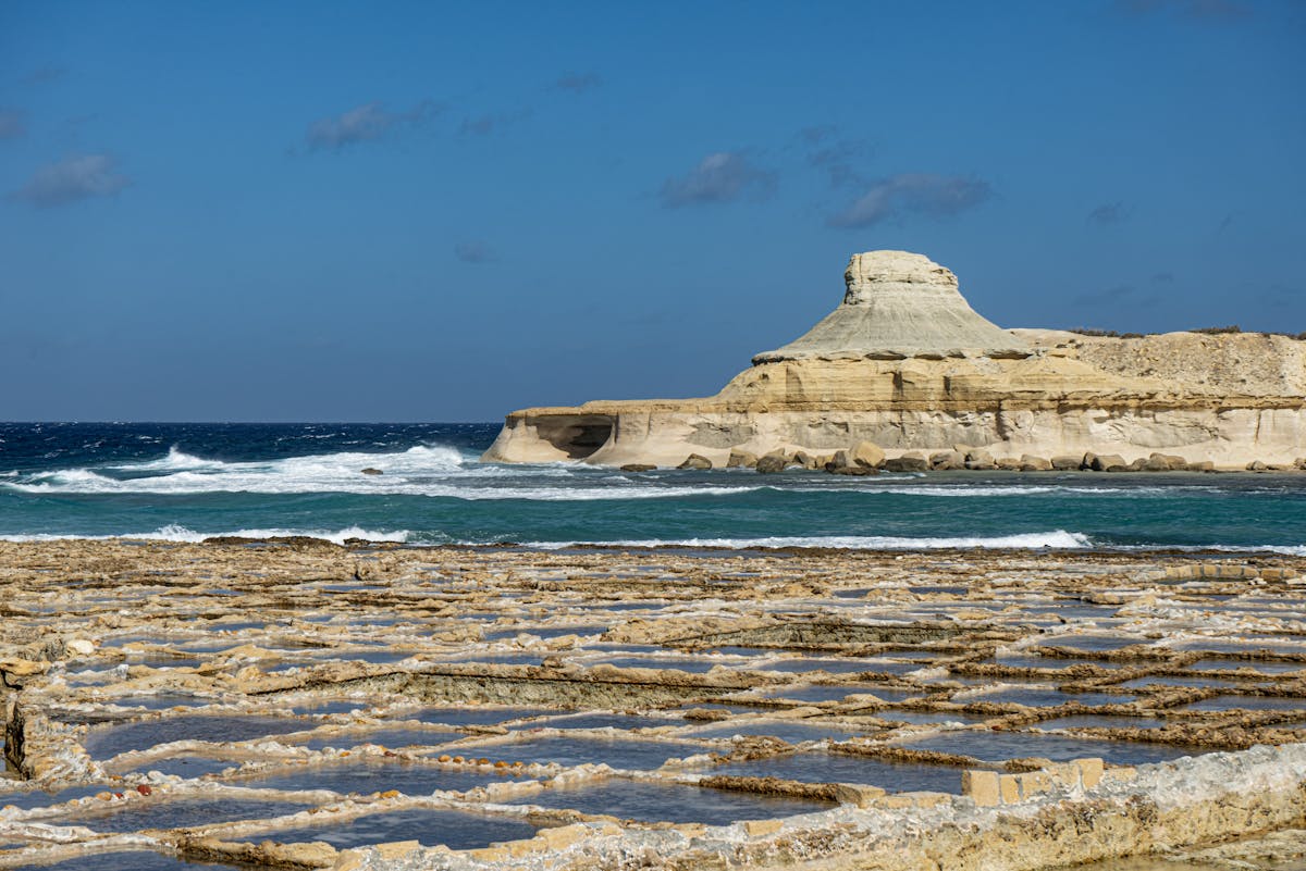 Salt pans carved into rocky coastline in Gozo Malta