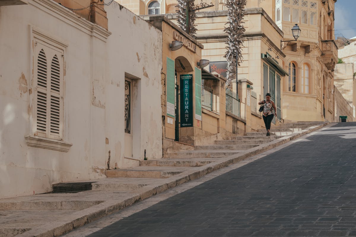 A woman walking along a street in Victoria Gozo Malta
