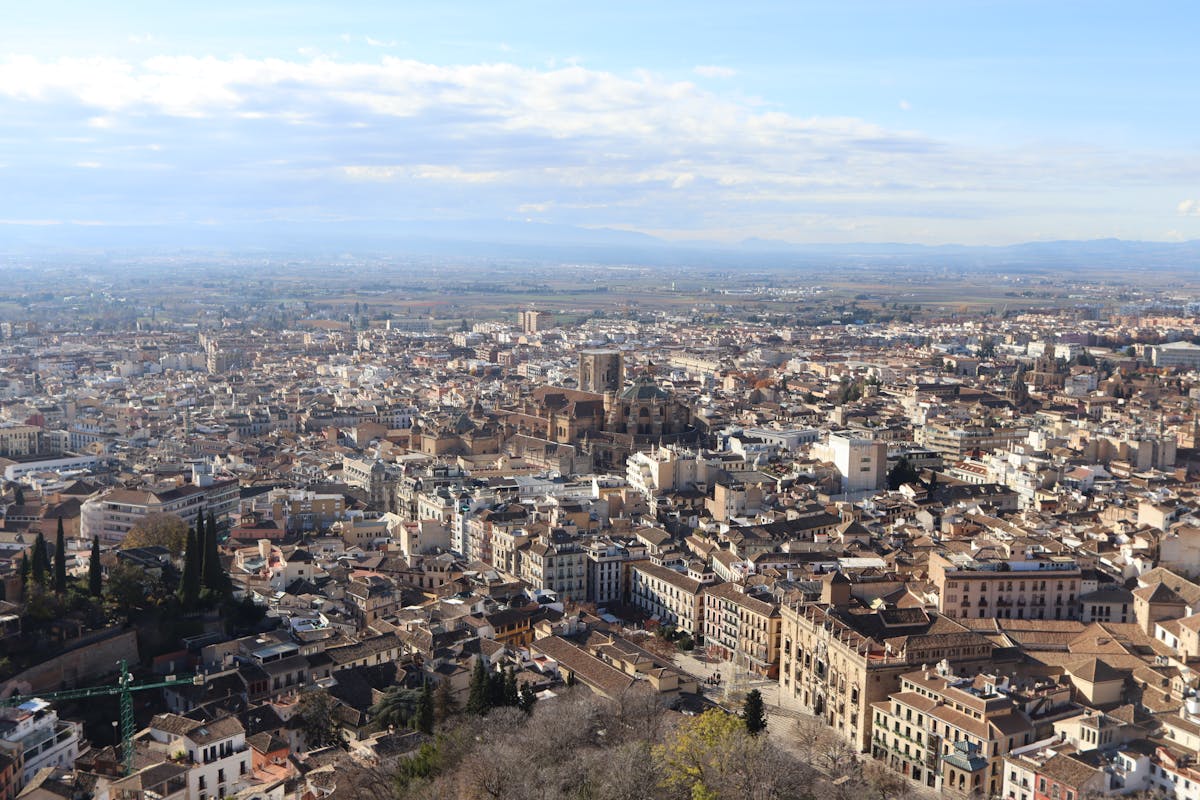 Aerial view of Granada cityscape with the Alhambra palace complex visible among the hills