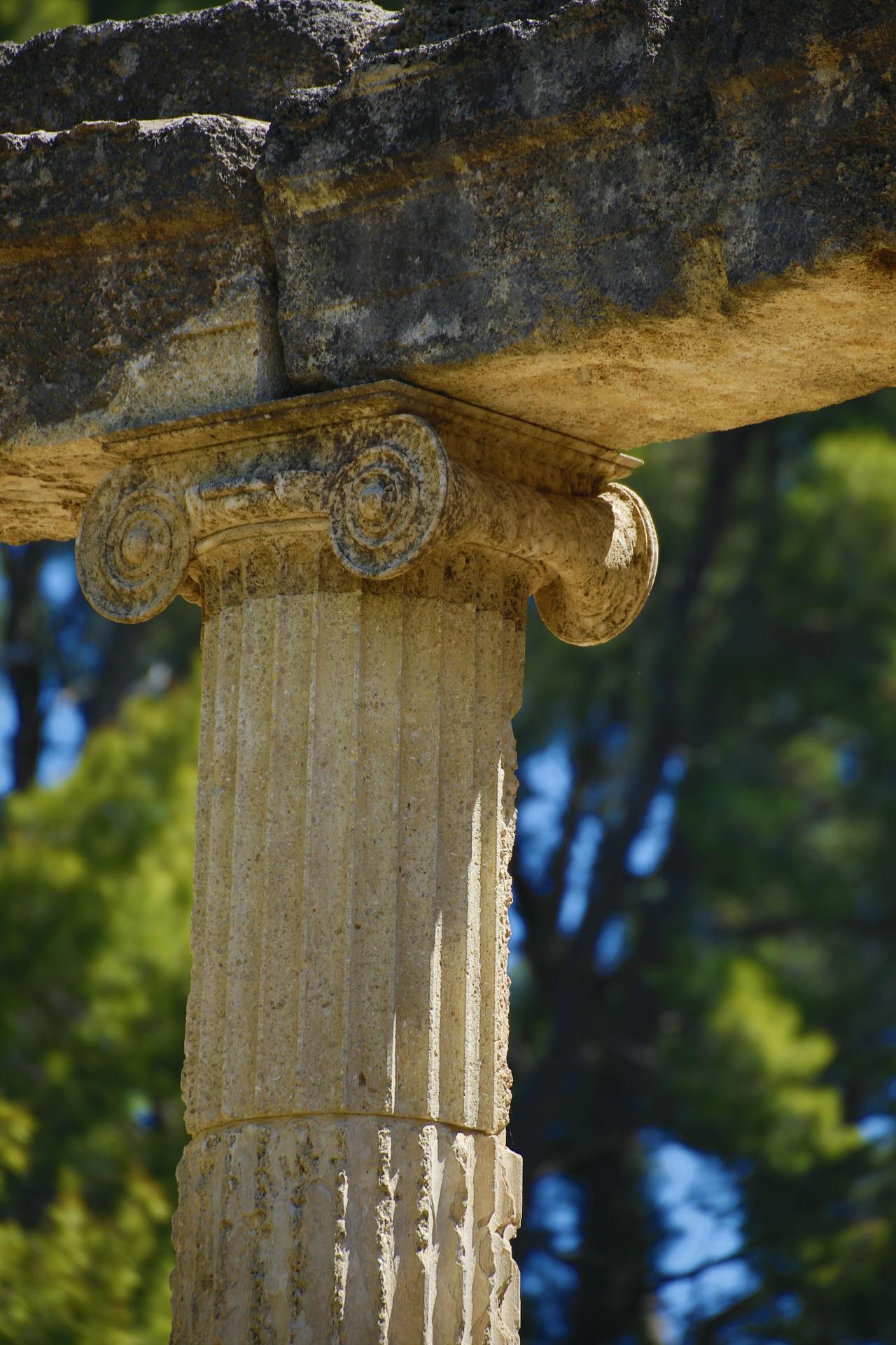 Ancient Greek marble columns standing against a blue sky