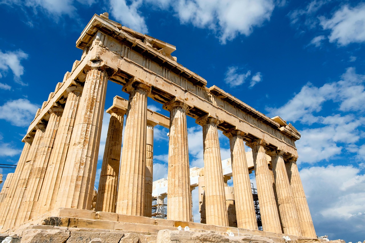 Ancient Greek temple with columns standing among overgrown ruins