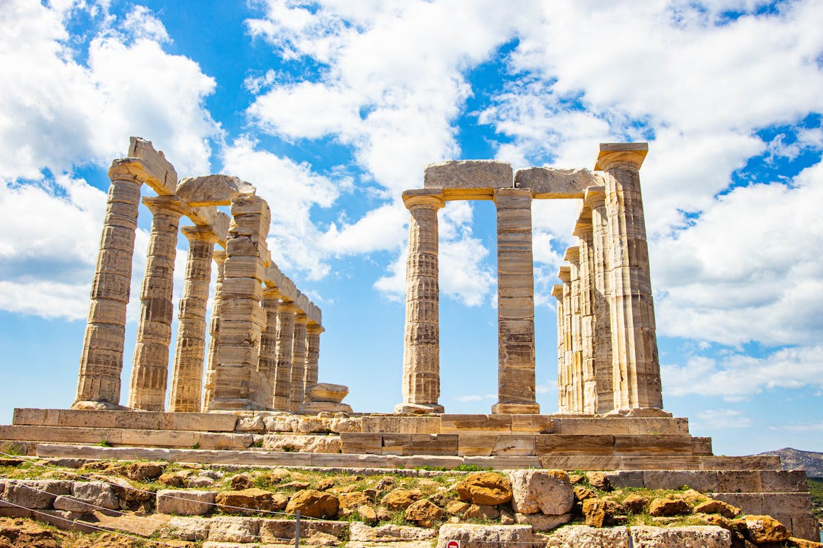Stunning ruins of an ancient Greek temple with tall columns under a blue sky