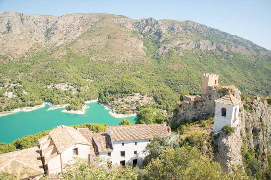 Panoramic view of Guadalest Castle with turquoise lake and mountains