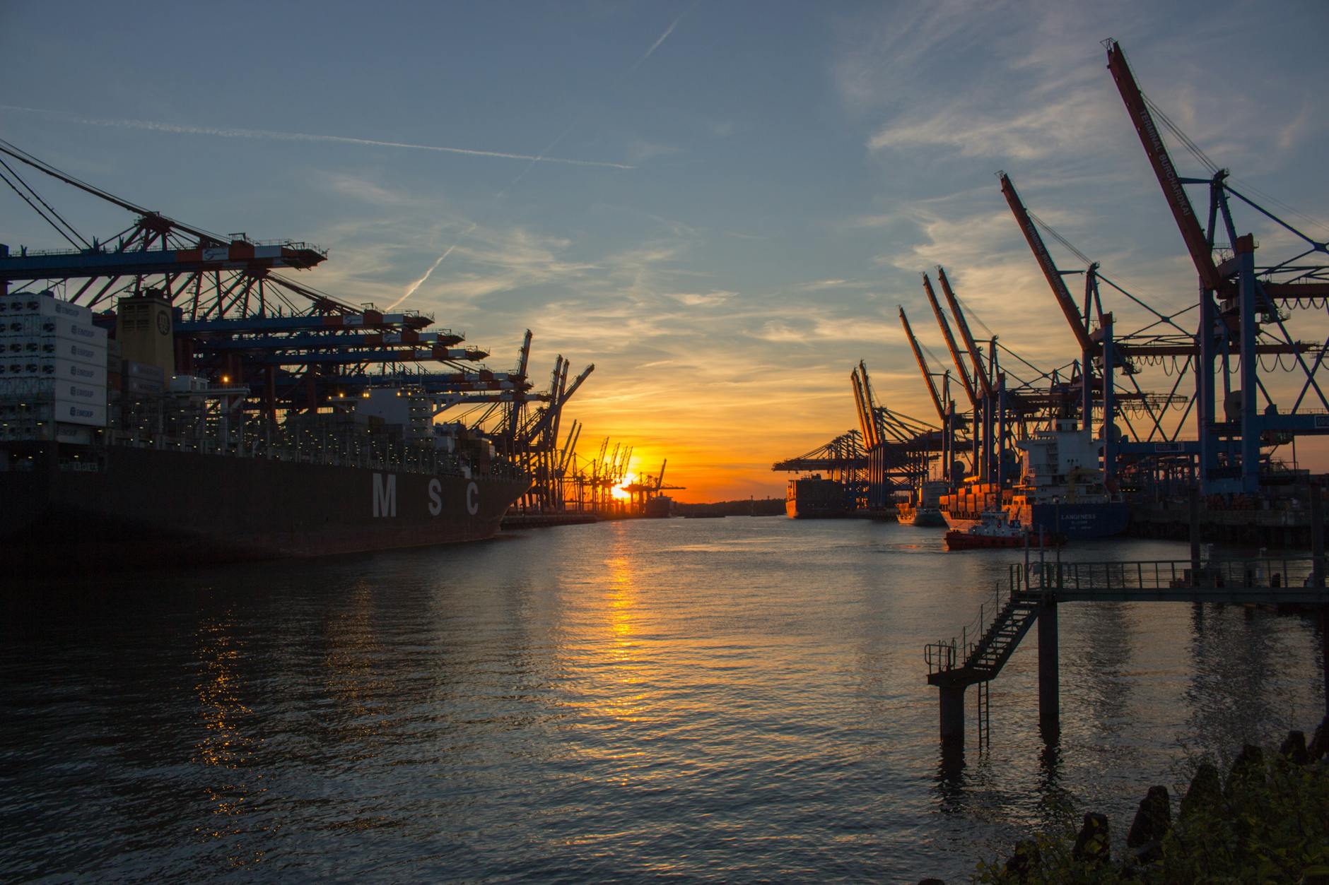 Hamburg port at sunset with shipping cranes and vessels