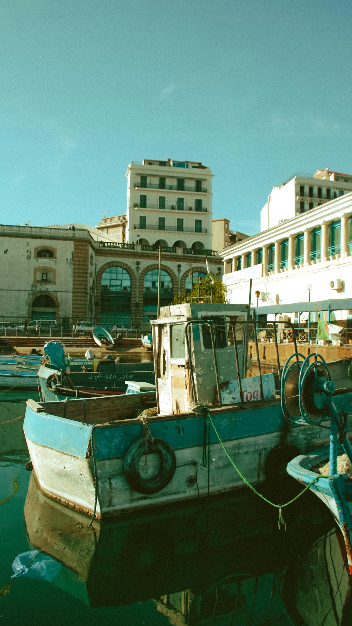 Colourful fishing boats moored in a Mediterranean harbour under blue skies