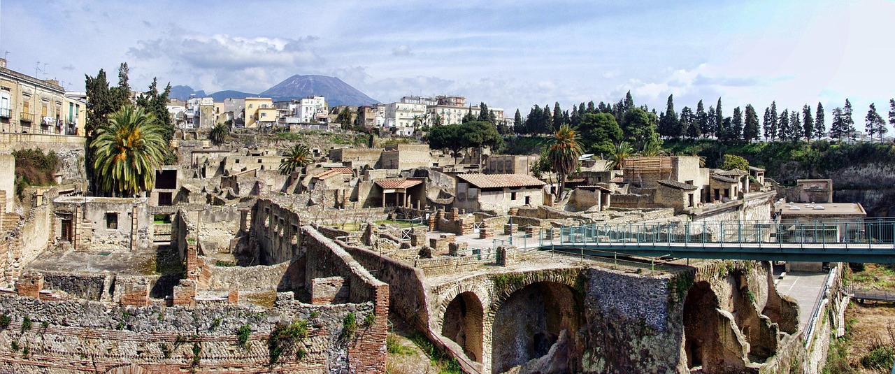Panoramic view of the Herculaneum archaeological ruins with modern apartment buildings visible above