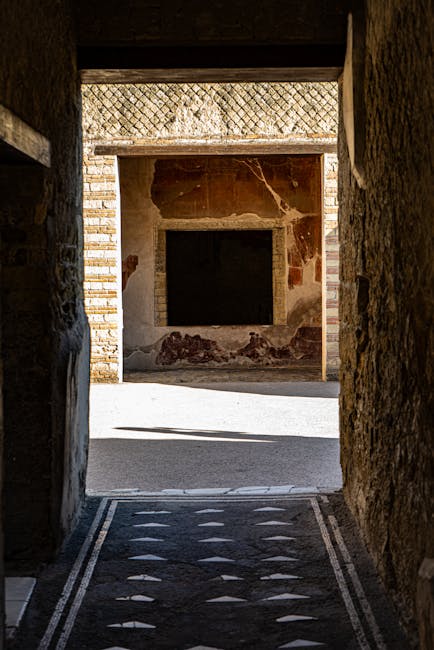 A dark passageway leading into the sunlit ruins of Herculaneum Italy