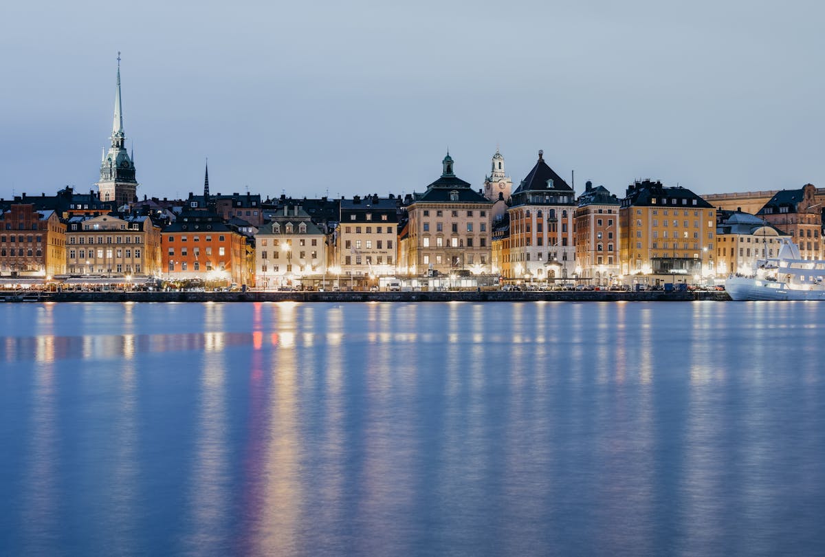 Stockholm Gamla Stan waterfront buildings reflected in water at twilight