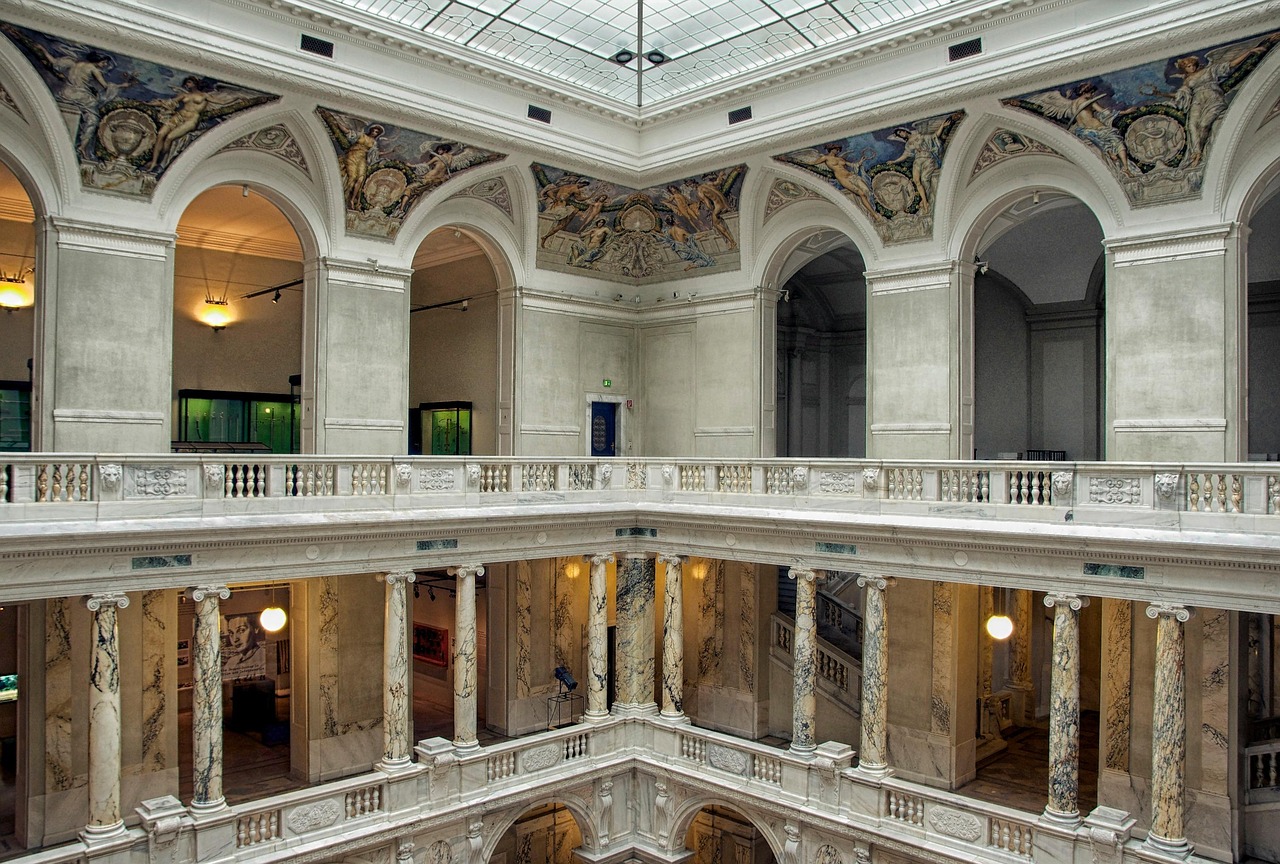 Ornate interior hall of Hofburg Palace with marble columns and decorative ceiling