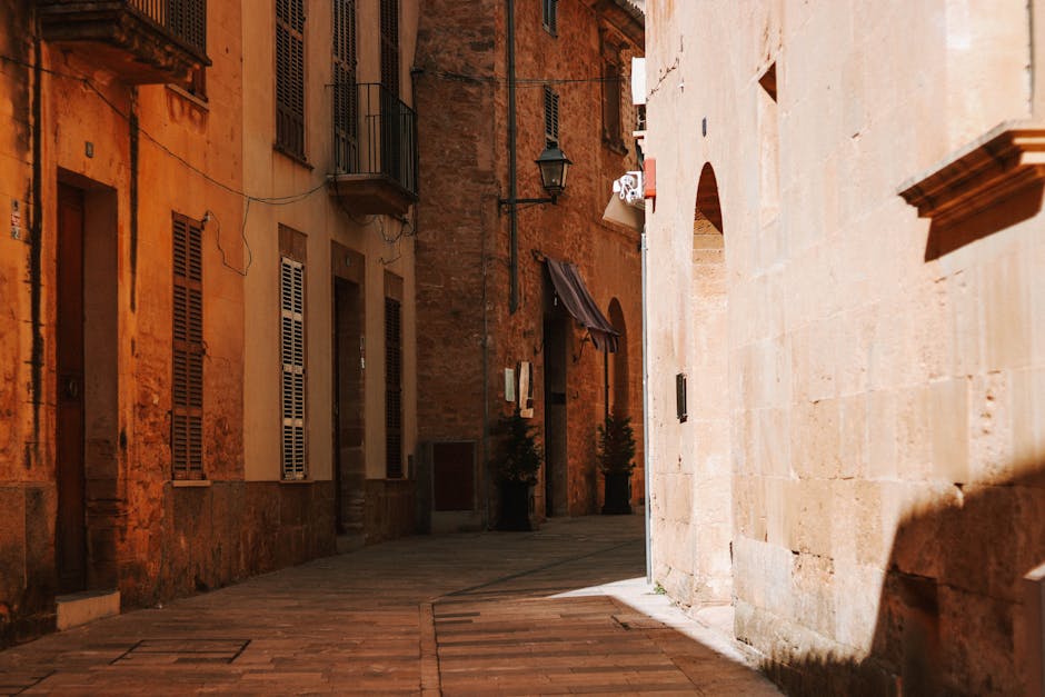 Sunlit alleyway with rustic buildings in Mallorca