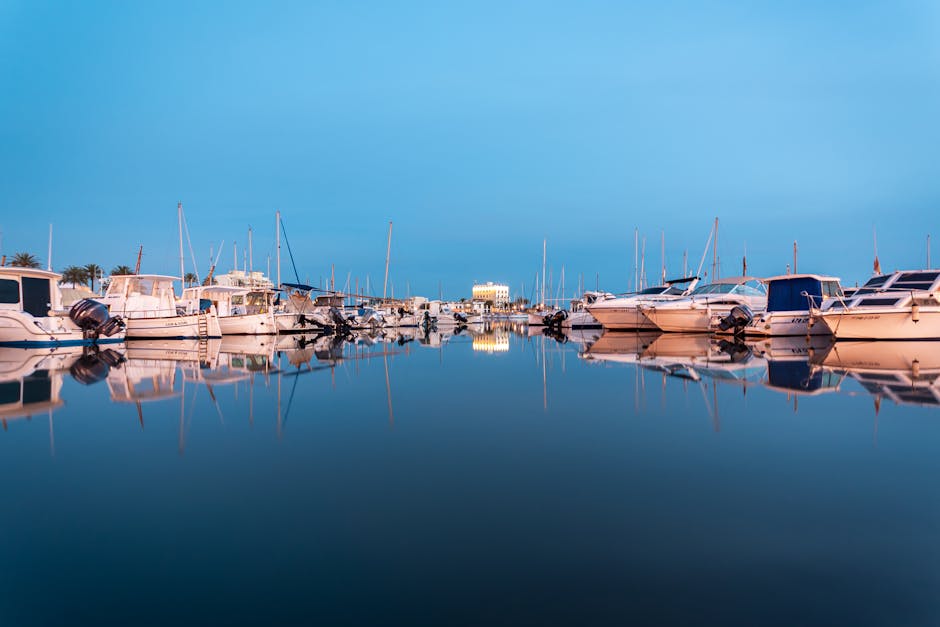Palma de Mallorca marina at twilight with boats reflected on calm water