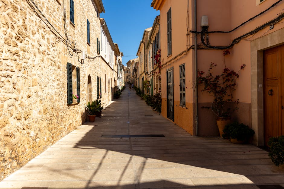 Charming narrow alley in Palma old town under blue skies