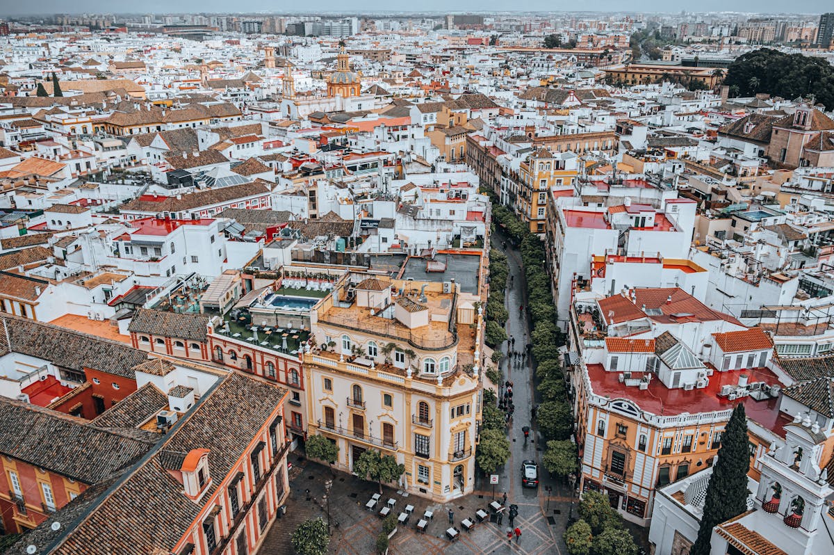 Aerial view of Seville historic cityscape with terracotta rooftops and church towers