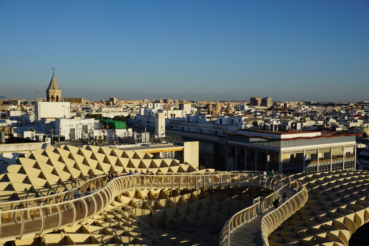 The Metropol Parasol wooden structure against the Seville skyline under a clear blue sky