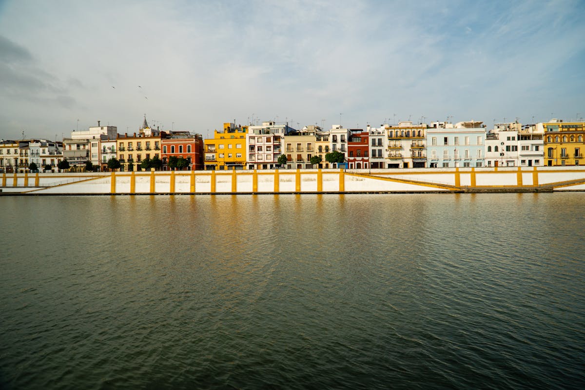 Colorful waterfront houses along the Guadalquivir River in Seville Spain