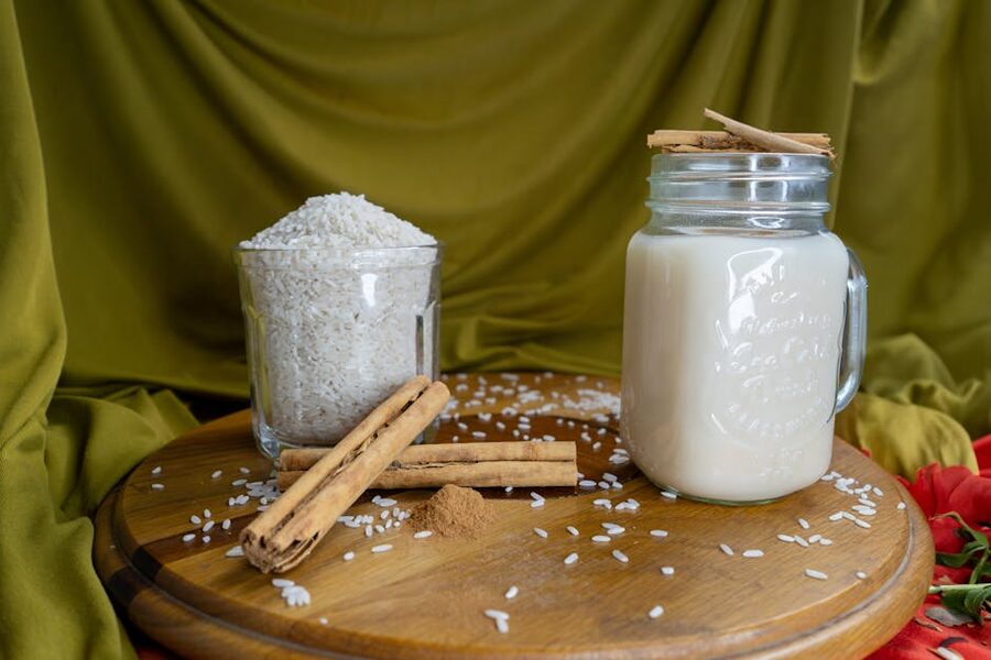 Jar of horchata with cinnamon and rice on a wooden surface